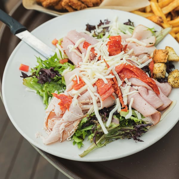 Inky's chef salad with ham, turkey, pepperoni, shredded cheese, croutons, and mixed greens.